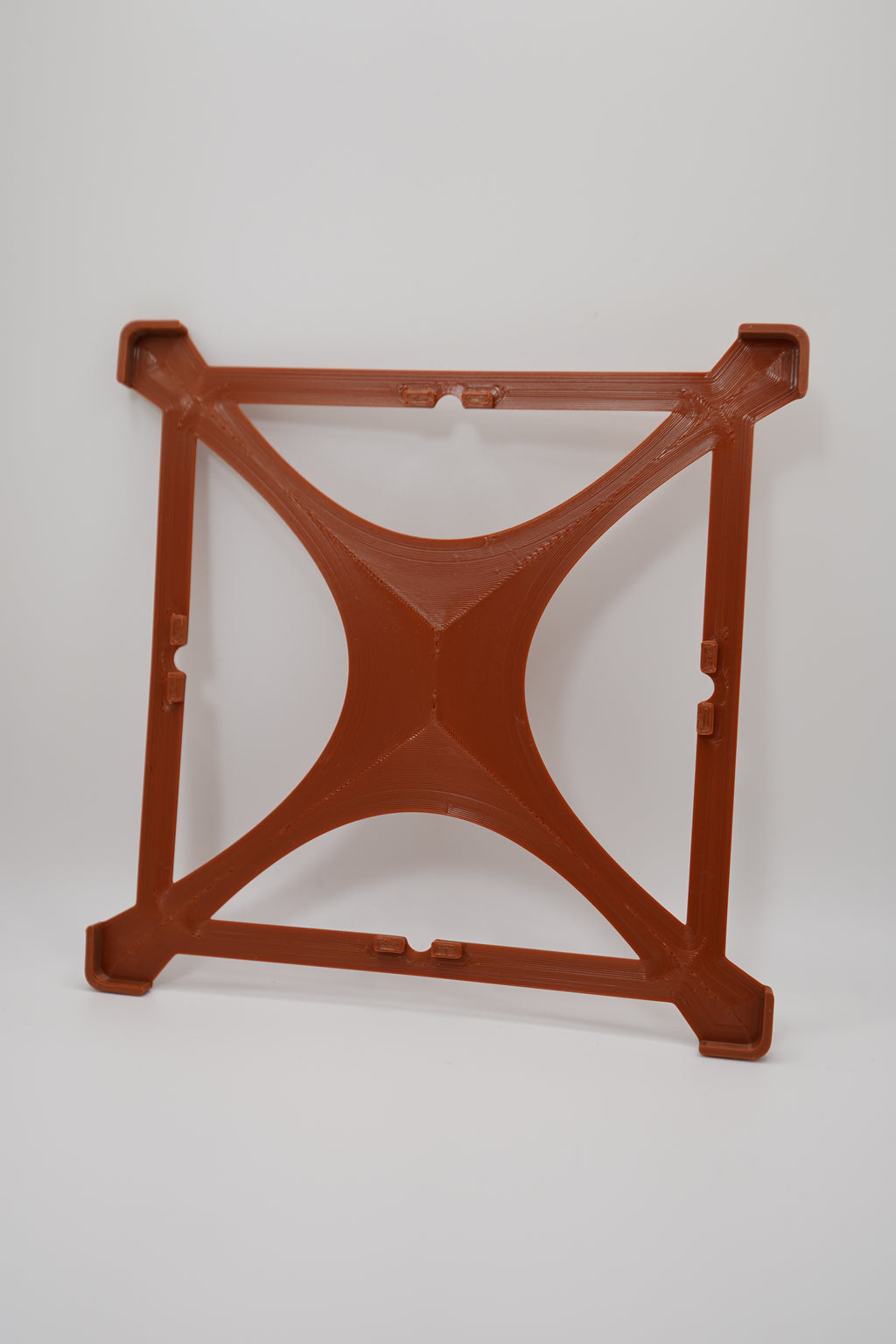 Low Profile Frame in brown, a minimalist four-corner frame shown without a panel